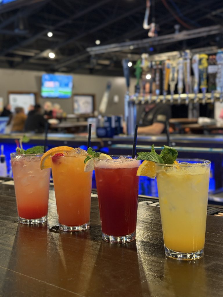 Four mocktails lined up on the bar at Twain's Tavern